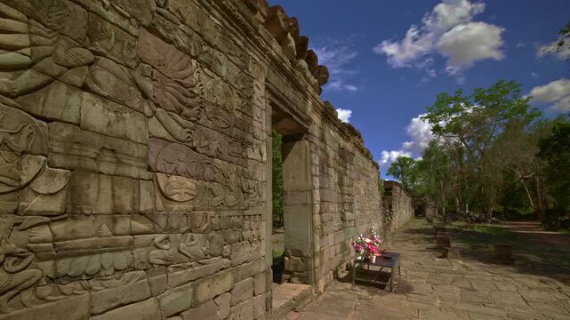 Avalokitesvara, also known as Lokesvara, the multi armed carvings in gallery with moving clouds in Banteay Chhmar Motion control dynamic movement time lapse.