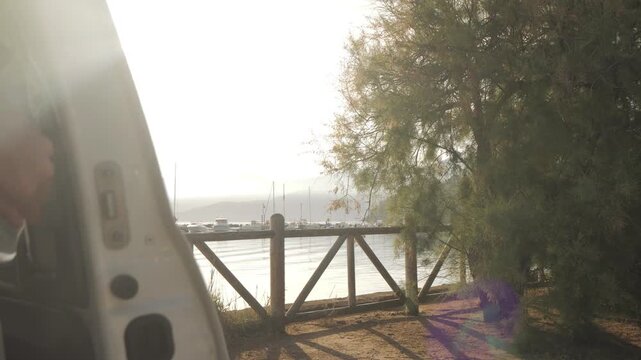 Van life sliding door opening at dawn, Elba island, Italy