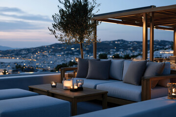 Fototapeta premium This image captures a stylish outdoor seating area adorned with cushions and candles, providing a serene spot to enjoy an incredible sunset view over the distant hills.