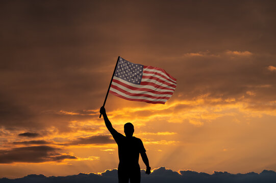 Man with National flag of United States of America in sky