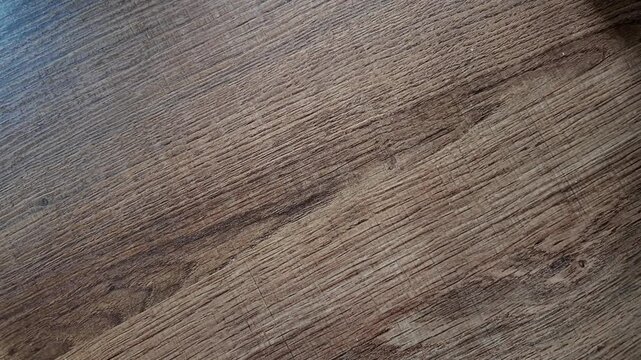 Hand rolling a dice on rustic wooden table