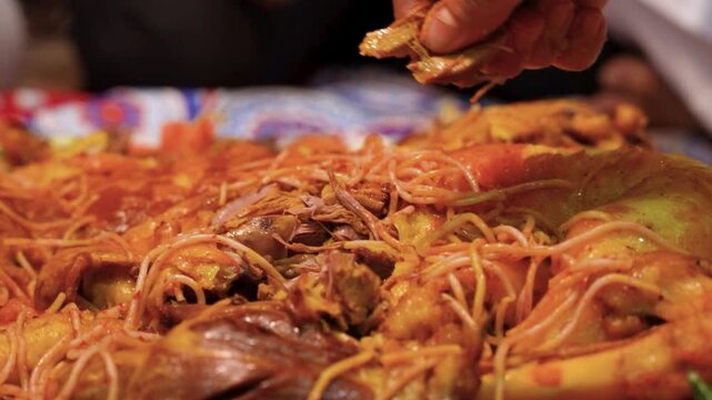 Saudi Man Enjoying Lamb Mandi with His Right Hand in the Majlis