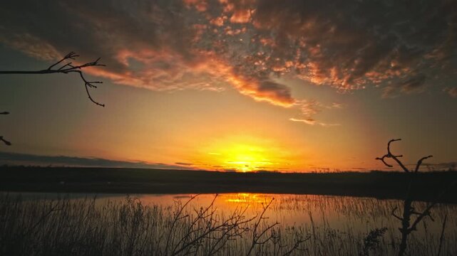 Magical sunset timelapse over calm lake Vinnytsia region Ukraine. Beautiful dramatic evening sky changing colors, fast moving clouds reflecting water surface. Peaceful countryside nature scenery, summ