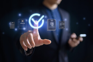 Fototapeta premium Businessman pointing at virtual tick mark on screen in concept of practices and policies , procedure company articles of association Terms and Conditions compliance rules and law regulation policy.