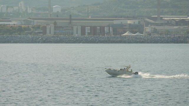 Inflatable boat at sunset on calm sea near Piombino, Italy