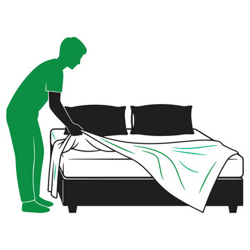 professional maid making bed with fresh white linens in modern bedroom