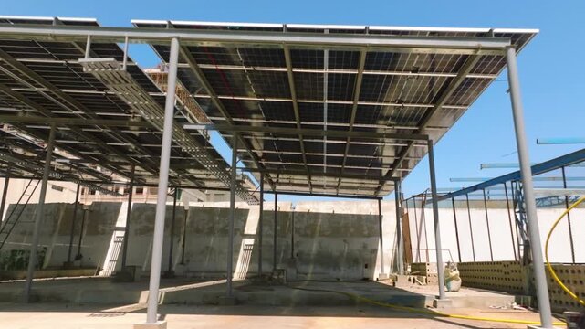 Camera glides under solar panels then tilts up to frame the canopy, Karachi.
