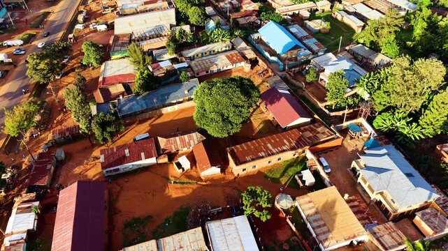 kenya roads, rural roads, poor rural settlement, damaged road with drone tracking vehicles over the road in the air.