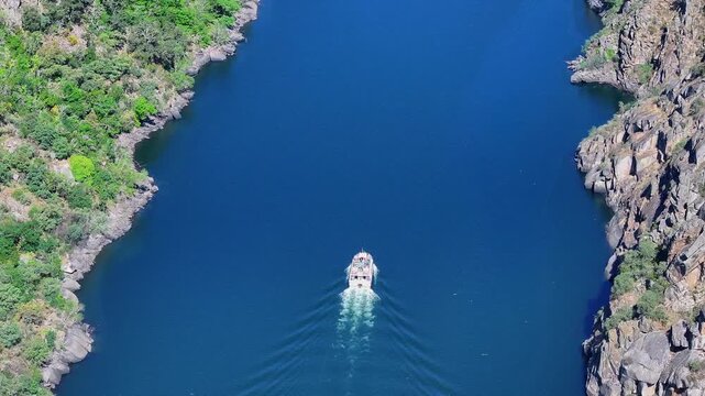 Motor Boat Across The Sil River From Cadeiras Viewpoint In Sober, Spain. Aerial Tilt-up Shot