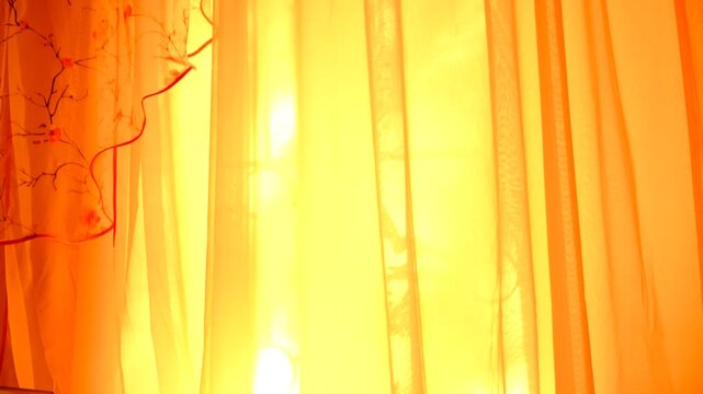 Summer solstice bathes the room in a magical light. Soft rays of sunlight stream through a sheer, transparent curtain, diffusing into a warm, golden glow that fills the cozy bedroom. Atmospheric mood