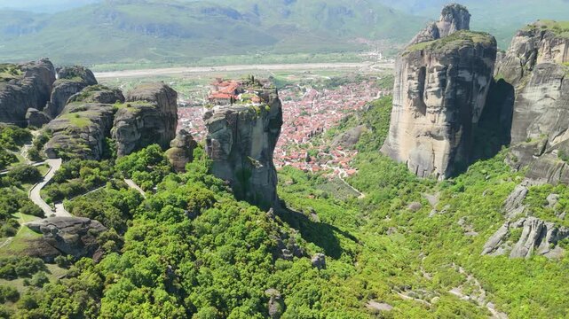 Drone view of Holy Trinity (Agia Triada) Tzagaroli Monastery and Meteora rocks high over the city of Kalabaka, Greece
