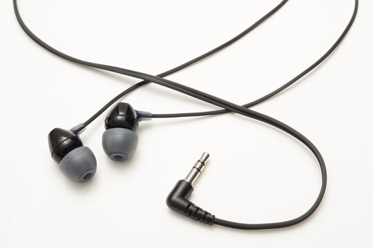 Wired earbuds isolated on a white background with a clean minimal design and detailed audio accessory appearance.