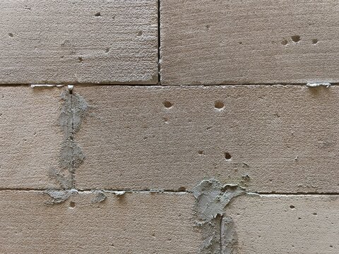 Minimalist rustic tan hebel brick wall texture backdrop for graphic design copy space