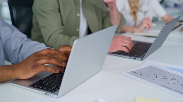 Close up unrecognizable business team typing laptops gadgets three diversity businessmen businesswoman working process at table multiracial men work with computers woman writing holding digital tablet