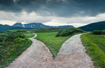 Fototapeta premium landscape of a fork in the road at storm weather, concept of insecurity of future