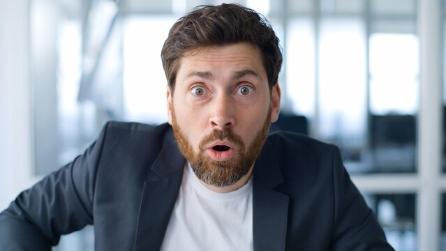 Portrait Caucasian middle-aged business man taking off glasses looking at camera amazed shocked corporate news reaction at office stunned mature businessman take off eyeglasses male feeling shock