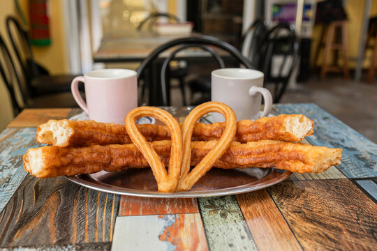 Traditional cafe breakfast with coffee, churros and porras