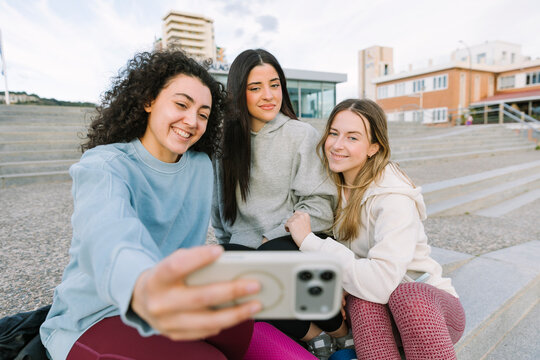 Three young women friends taking a selfie outdoors together