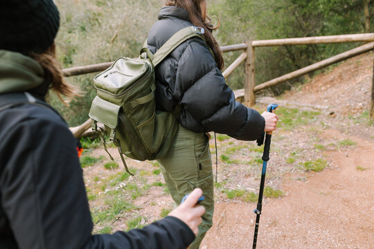 Winter mountain hiking with backpack and trekking pole