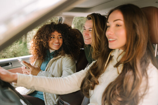 Friends enjoying a winter road trip adventure in a car