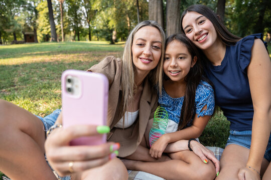 Family taking selfie during summer picnic in park