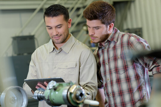 two men working at a factory