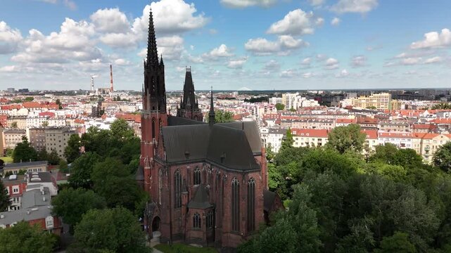 Aerial view of city park with green trees Gothic church and urban skyline in Wrocław Poland