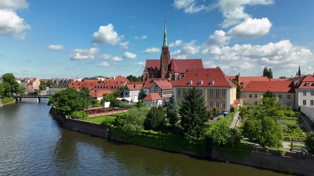 Aerial footage of the river and the city center of Wroclaw. Collegiate Church of the Holy Cross and St. Bartholomew