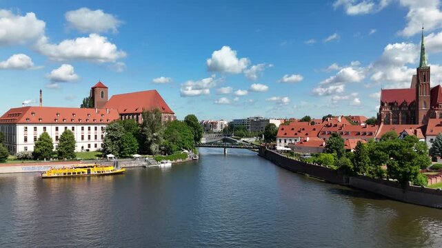Aerial footage of the river and the city center of Wroclaw. Collegiate Church of the Holy Cross and St. Bartholomew