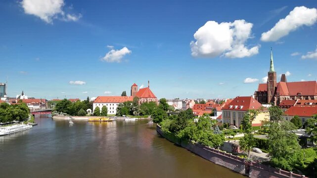 Aerial footage of the river and the city center of Wroclaw. Collegiate Church of the Holy Cross and St. Bartholomew
