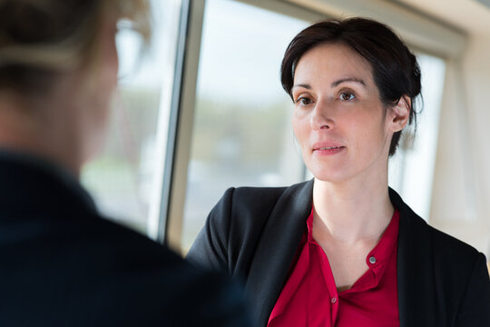 an aprehensive businesswoman in conversation