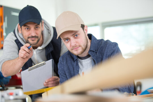 two wood designer working in workshop