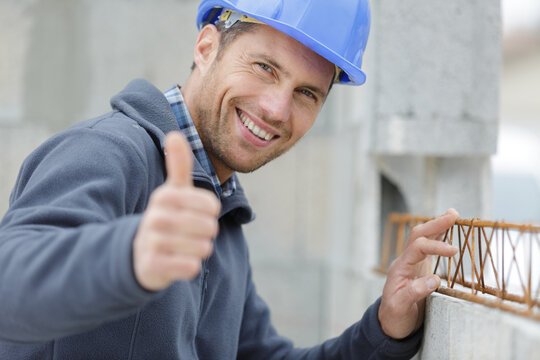 smiling worker showing thumb up