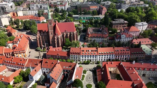 Aerial footage of the river and the city center of Wroclaw. Collegiate Church of the Holy Cross and St. Bartholomew