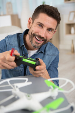 a man playing with a small quadrocopter drone