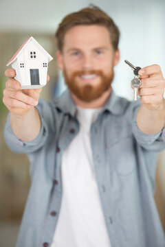 young man holding house key