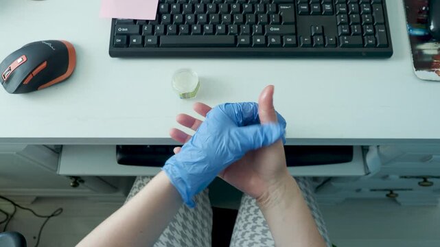 Treating thumb tendon pain beside keyboard in home office workspace