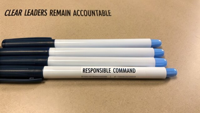 Pens Lying on Desk with Inspirational Text and Clear Message About Leadership and Accountability in Corporate Environment