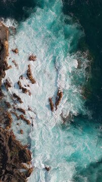 Vertical aerial drone waves on lava coastline Tenerife &mdash; portrait format
