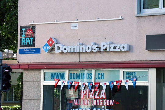 Basel, Switzerland, May 24, 2026: Domino's Pizza Store Exterior with Street Art in Urban Setting
