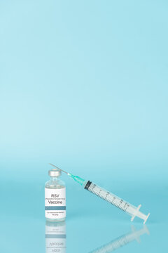 RSV vaccine vial bottle with syringe on blue background. Respiratory Syncytial Virus vaccine protect older adults and infants from severe lower respiratory tract diseases.