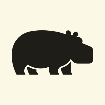 Black silhouette of a hippopotamus standing.