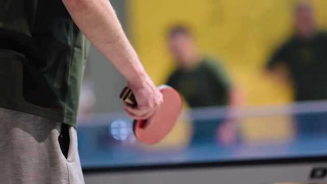 Ping pong match takes place in a sports center with players showing skills and strategy