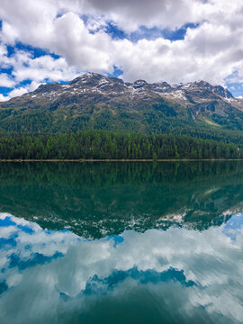 Snow-Capped Alpine Mountains Reflected in a Crystal Clear Lake in Switzerland