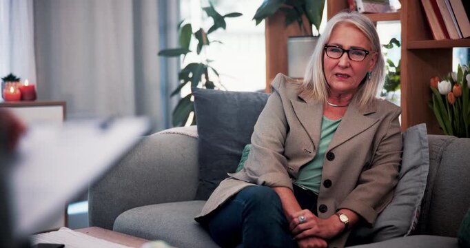 Therapy, counselor or mature woman in office, mental health evaluation or coping skills discussion. Talk, client or psychologist with storytelling for emotional processing, support or trauma recovery