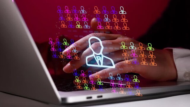 Hands typing on a laptop screen with colorful user icons representing social media activity and online networking