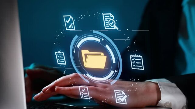 Hand using computer to manage files and data during office work at night