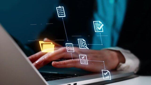 Working on a laptop with digital icons showing files and tasks in a modern office setting at night