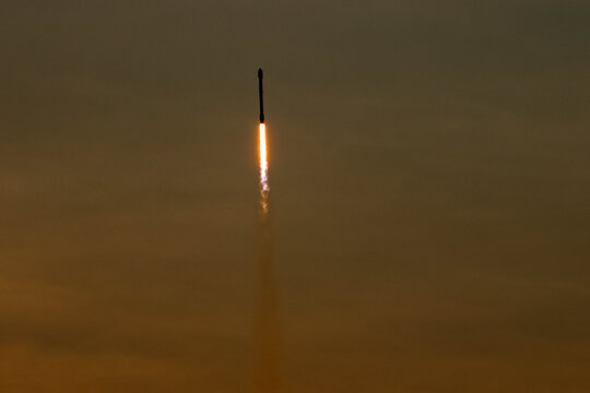 Falcon 9 Ascending Through Sunrise Clouds Over Florida
