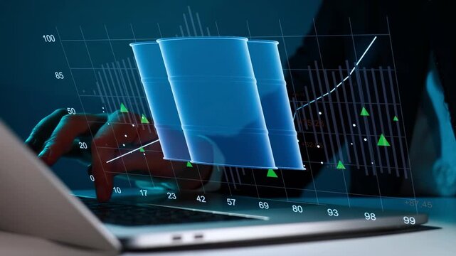 Data analysis shows oil barrel trends with graphs on a laptop at a desk in a dark office environment